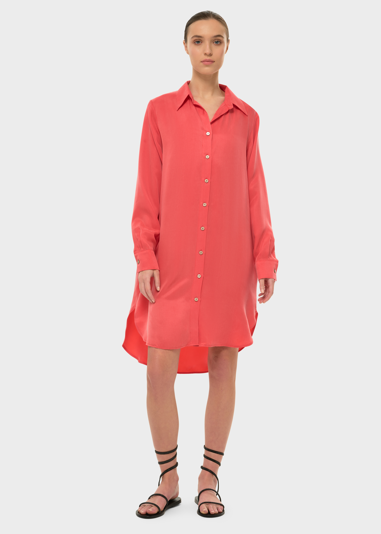 Woman wearing an orange long-sleeve button-front shirt dress