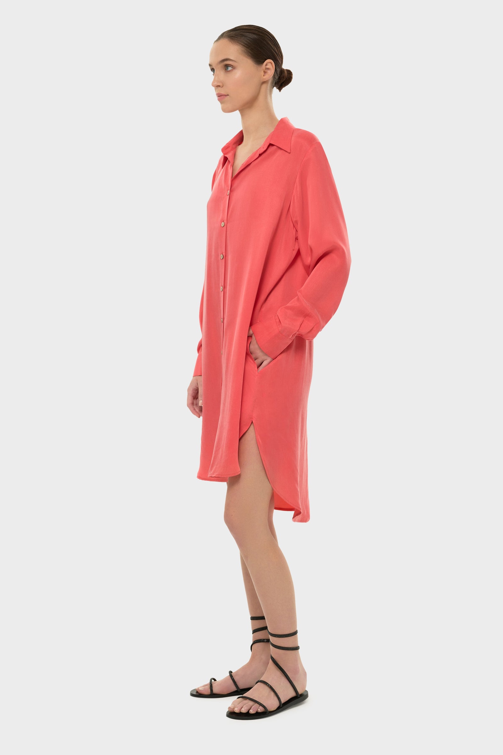 Woman wearing an orange long-sleeve button-front shirt dress
