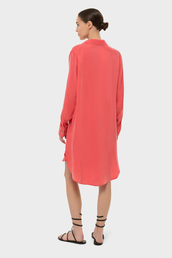 Woman wearing an orange long-sleeve button-front shirt dress