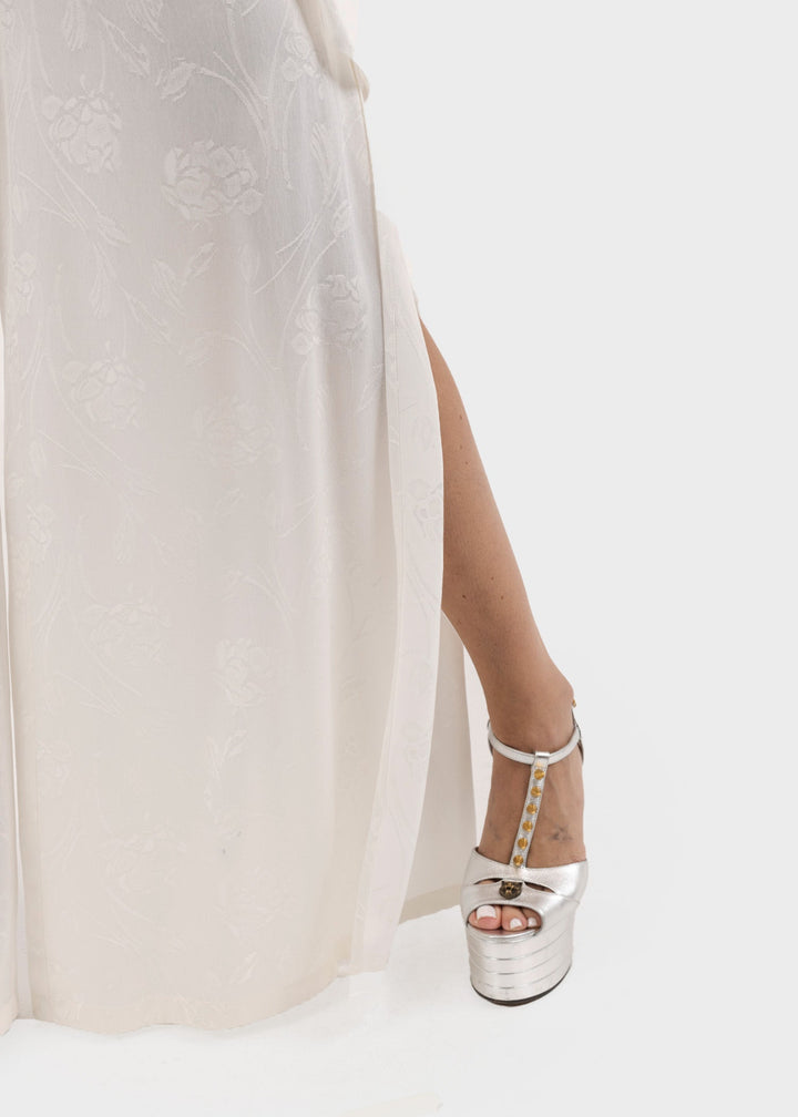 Woman wearing white wide-leg flared pants with a flowing silhouette