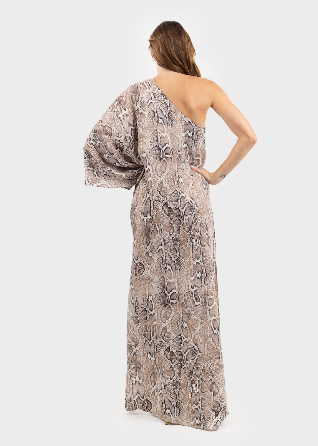 Woman wearing a gray and white snake print one-shoulder sleeveless maxi dress