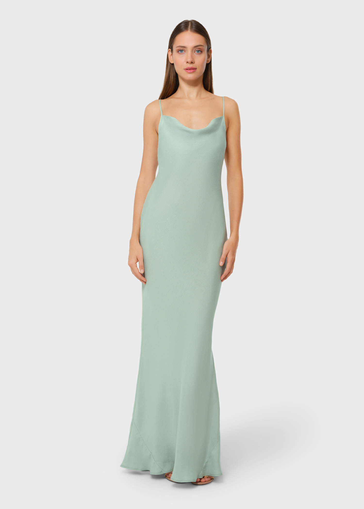 Woman wearing mint green vegan silk slip maxi dress, front view