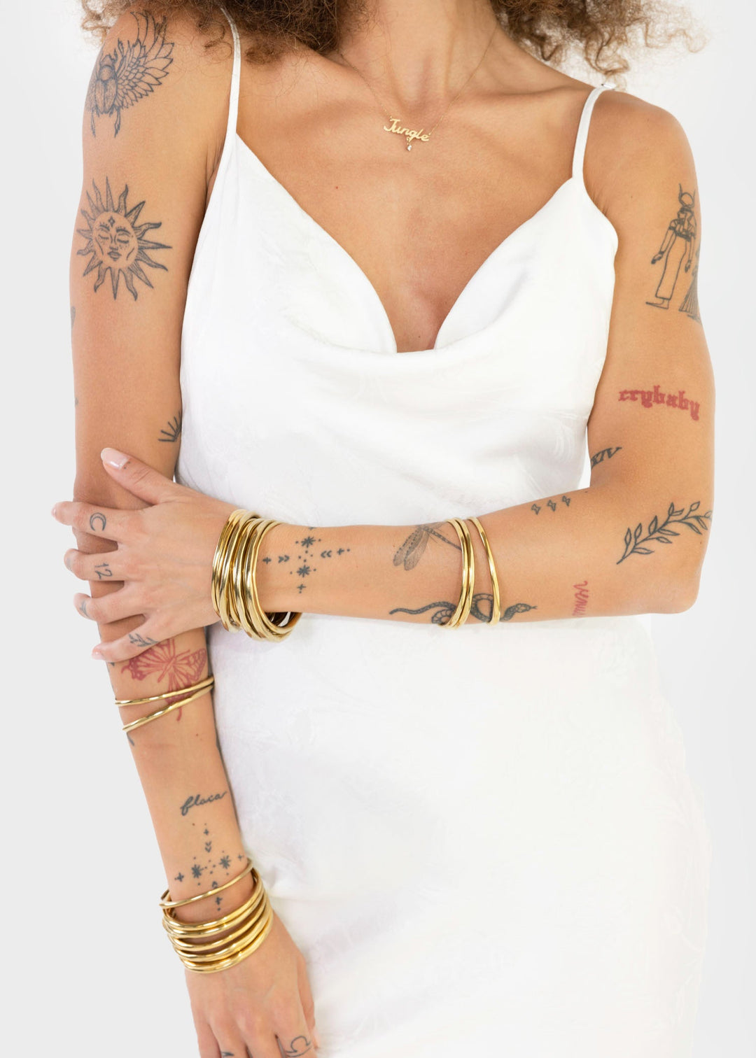 Woman wearing a white sleeveless slip dress with a V-neckline and maxi length