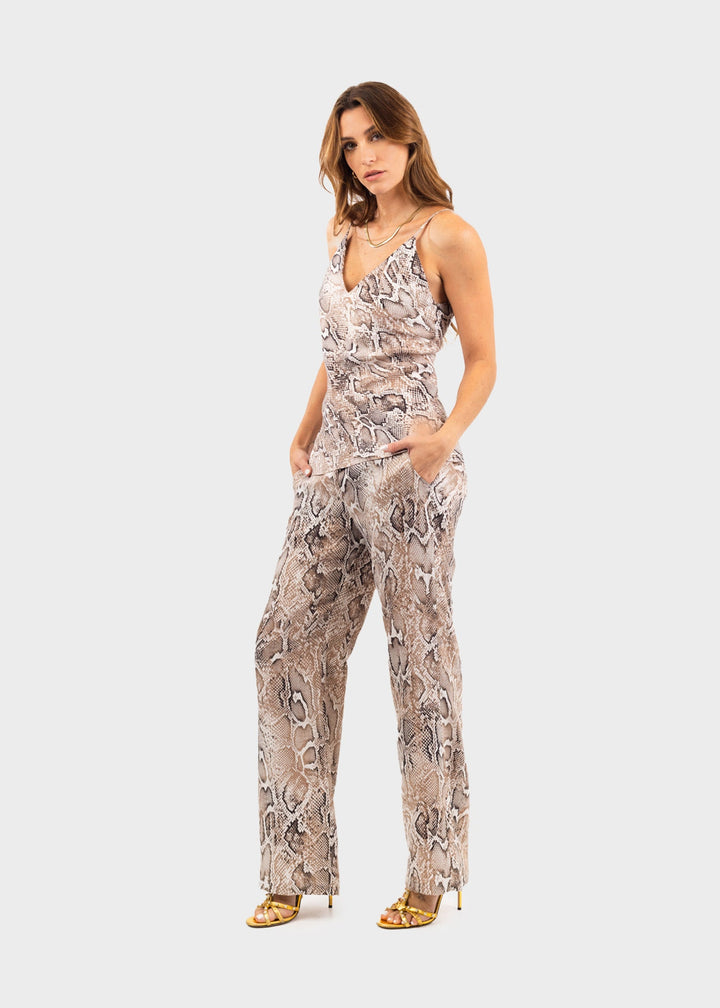 Woman wearing a gray and white snake print crop top with matching wide-leg pants